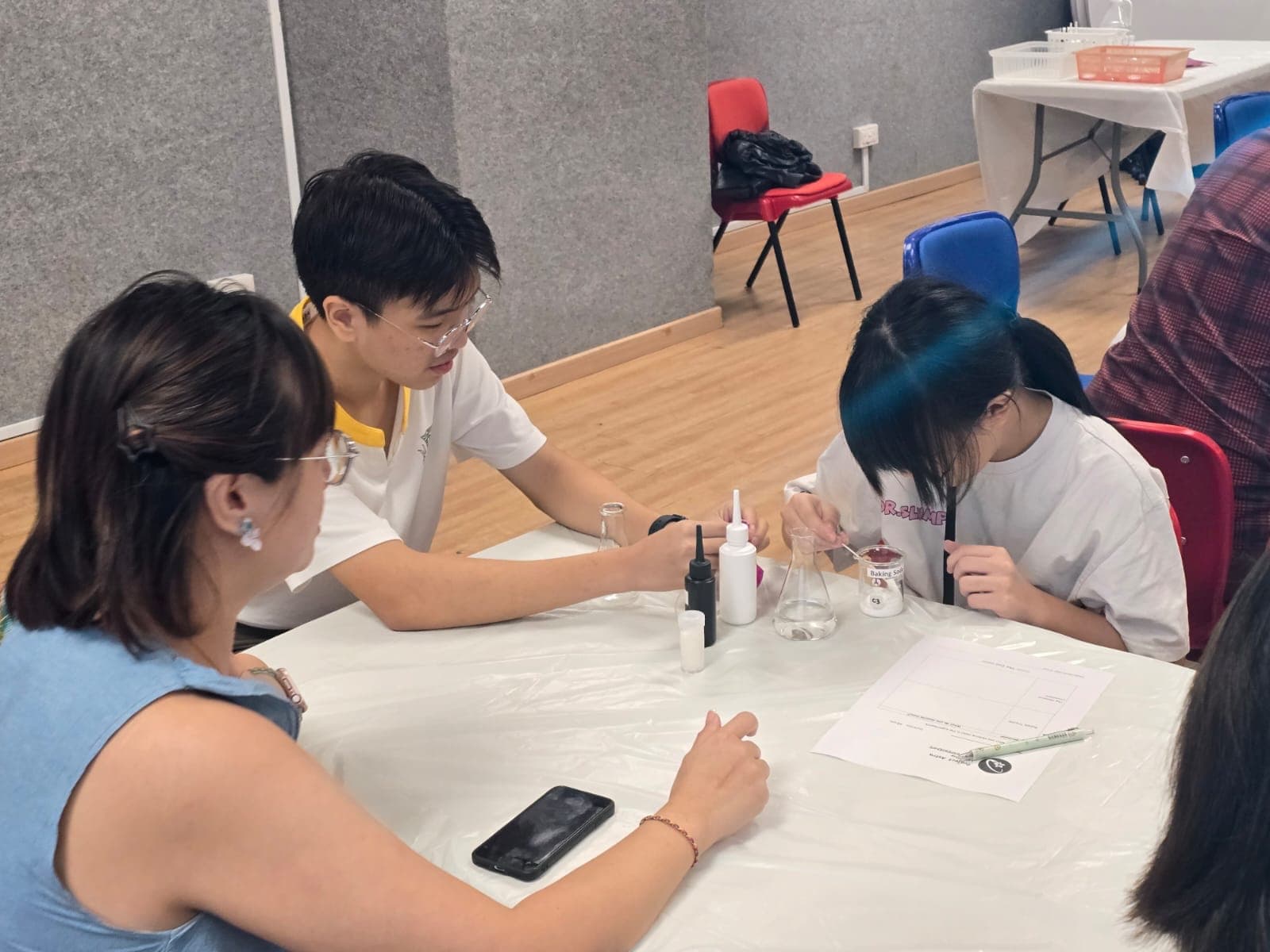 Astra volunteer facilitator coaching a student during a hands-on science session